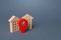 Red location pin and houses. Location concept, settlement. Tracking, internet of things. City navigation, orienteering. Search