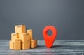 Red location pointer geolocation symbol and cardboard boxes. Distribution delivery of goods, freight transportation shipment.