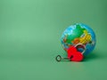 Red lock with key and earth globe on a green screen. Royalty Free Stock Photo