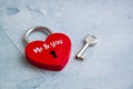 Red lock with key on the wooden background. Valentine`s or Wedding`s day postcard concept.