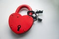 Red lock with keys and two wedding rings on a white background Royalty Free Stock Photo