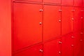 Red locker room with closed doors. Free service in fitness