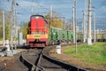 Red locomotive and Green freight cars