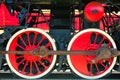 Red locomotive wheel with black mechanisms Royalty Free Stock Photo
