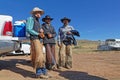 Three cowboys rest on their truck in Montana