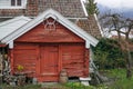 Red wooden cabin along fjord in Norway