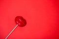 Red lollipop on coral background