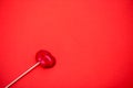 Red lollipop on coral background