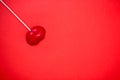 Red lollipop on coral background