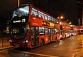 Red London buses outside Euston railway station.