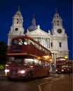 Red London Routemaster bus moving past St Pauls Cathedral Transport Movement