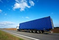 Red lorry with grey trailer over blue sky Royalty Free Stock Photo