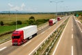 Red Lorry trucks in line on a country highway Royalty Free Stock Photo