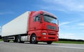 Red lorry with white trailer over blue sky Royalty Free Stock Photo