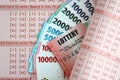Red lottery ticket lies on pink gambling sheets with indonesian rupiah money bills Royalty Free Stock Photo