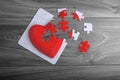 Red love heart puzzle with loose pieces