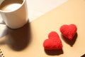 Red love hearts on brown paper note with a cup of coffee. Royalty Free Stock Photo