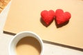 Red love hearts on brown paper note with a cup of coffee. Royalty Free Stock Photo