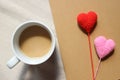 Red love hearts on brown paper note with a cup of coffee. Royalty Free Stock Photo