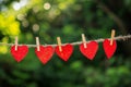 red love hearts pegged onto a clothes line outdoors