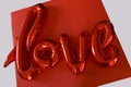 Red love letters valentine day gift balloon gel air top view white backdround Royalty Free Stock Photo