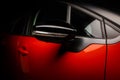 Red sports car on a black background. Dark atmosphere of a super car.