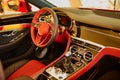 Red luxury car Interior. Steering wheel, shift lever and dashboard. Shallow doff