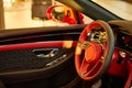 Red luxury car Interior. Steering wheel, shift lever and dashboard. Shallow doff Royalty Free Stock Photo