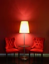 Red luxury chairs with table and lamp