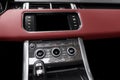 Red luxury modern car Interior. Shift lever and dashboard. Detail of modern car interior. Automatic gear stick. Part of leather