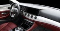 Red luxury modern car Interior. Steering wheel, shift lever and dashboard. Detail of modern car interior. Automatic gear stick.