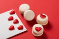 Red Macarons and red shaped hearten an envelope Royalty Free Stock Photo