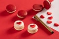 Red Macarons and red shaped hearten an envelope