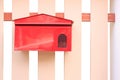 Red mail box hanging on fence Royalty Free Stock Photo