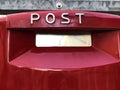 Red mailbox on a brick wall with Post text on it close-up. mailing concept Royalty Free Stock Photo