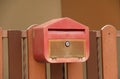 Red mailbox with brown wood fence. Royalty Free Stock Photo