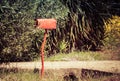 Red mailbox in a country road