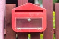 Red mailbox on fence Royalty Free Stock Photo