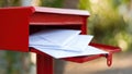 Red mailbox filled with letters, symbolizing communication and connection Royalty Free Stock Photo
