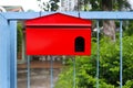 Red mailbox Hanging on the home fence Royalty Free Stock Photo