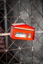 Red mailbox on an iron lattice gate. Logistics and mail Royalty Free Stock Photo