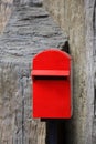 Red mailbox on rough wall Royalty Free Stock Photo
