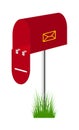 Red mailbox standing in the grass