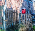 Red mailbox on a wooden fence Royalty Free Stock Photo