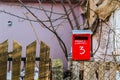 Red mailbox on a wooden fence Royalty Free Stock Photo