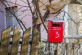 Red mailbox on a wooden fence Royalty Free Stock Photo