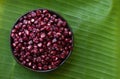 Red maize or corn fruits on green banana background.top view,flat lay Royalty Free Stock Photo