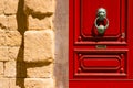 Red maltese door with old forged handle Royalty Free Stock Photo