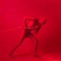 The red man drags something on a rope, a concept of labor and anxiety. Royalty Free Stock Photo