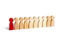 A red man stands with people in a row on a white background. The concept of exceptional and talented employee. Selection